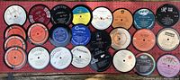 Array of 25 label vinyl coasters showing different music label designs and colors.