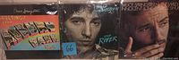 Front covers of three Bruce Springsteen vinyl records together, showing all titles and artwork, with The River record having a blue 66 sticker.