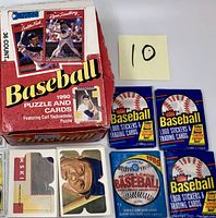 Top view showing 1990 Donruss Baseball Puzzle and Cards box with Carl Yastrzemski puzzle and three sealed 1989 Fleer Baseball Logo Stickers & Trading Cards packs plus one 1988 Major League Baseball sealed pack.