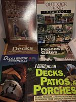 Photo showing six DIY handyman books including titles about decks, patios, porches, fences and gates, door and window essentials, the basement book, outdoor living idea book, and a home inspection and maintenance guide.
