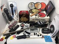 Full lot overview showing microphones, guitar parts, software, and collectibles in one image.