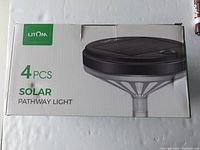 Box display for 4 solar pathway lights, Litom brand, showing front design and product image