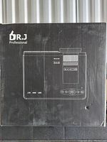 Box front showing DR.J Professional projector illustration with product features like LCD, USB, LED and control buttons.