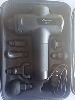 Top view of the Wattne W2 handheld massage gun in its foam carrying case with six interchangeable massage heads and charging cable.