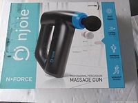 Front of the product box showing image of black and blue Njoie N-Force percussion massage gun and branding details