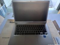 Open silver notebook laptop showing keyboard and screen.