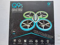 Front of the box showing drone image and features including speed control, lighting mode, 6-axis gyroscope, altitude hold, headless mode, 3D flips, one key return, emergency stop.