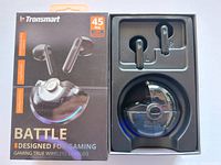 Photo showing Tronsmart Battle gaming earbuds in charging case, with original retail box beside them.