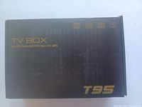 Closed outer box of T95 TV box with branding and technical details.