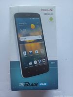 Front view of the ZTE Blade Spark smartphone box showing product image and branding.