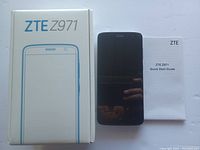 Front of ZTE Z971 phone, box, and Quick Start Guide visible on a white surface.