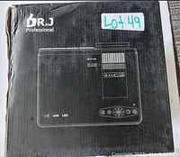 Closed black retail box showing white line drawing of projector, Dr.J Professional logo, ‘LCD USB LED’ markings and lot sticker