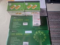Overview of the lot showing 4 mosquito killer boxes, 2 LED grow light boxes, and 2 LED headlamp boxes.