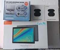 Photo showing the Vankyo MatrixPad S30 tablet box, Mini Game Anniversary Edition console box with 660 built-in games, and two boxes of HotHigh truly wireless earbuds in black.