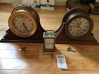 Overall view of two mantel clocks and carriage clock with three winding keys