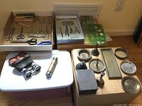 Wide shot of entire lot including scissors, drawing tools, miniature bowls and plates, bells, opera glasses, flashlight