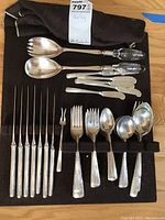 Full layout of all flatware pieces on black display case