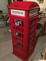 Front view of red telephone booth style cabinet