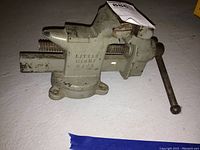 Side angle of gray cast metal vise showing brand and model 5494 embossed on body.