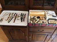 Overall view of two trays showing all watches on left and coins/jewelry on right
