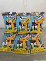 Six unopened DohVinci Basic Starter Sets shown arranged in two rows with yellow drawing tool and two tubes of compound each.