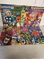 Full view of 8 assorted Marvel comic books including Ultimate Fantastic Four and Venom