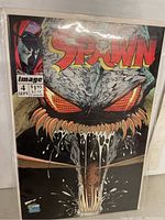 Front cover of Spawn Issue No. 4 comic with dramatic illustration of monster face and Spawn logo.