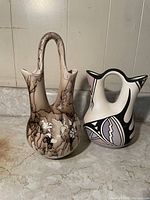 Photo shows two Native American wedding vases side by side, highlighting size and color contrasts