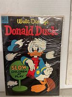 Front cover of vintage Walt Disney Donald Duck comic, issue 39, showing Donald Duck with a 'Slow Children at Play' sign. Includes Dell Comic logo and 10 cent price marking.