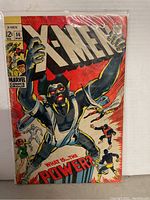 Full front cover image showing the X-Men 56 comic with the primary character and background heroes.