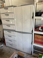 Photo showing the entire four shelf storage cabinet with four drawers on left and two louvered doors on right.