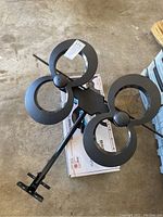 Top view of the black outdoor TV antenna showing four circular loop elements and mounting pole.