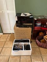 Full lot showing Pyle receiver on box with cables, remote, and speakers packed in foam box.