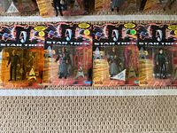 Five Star Trek Generations collectible action figures with closed original packaging showing uniformed characters and starfield backgrounds.