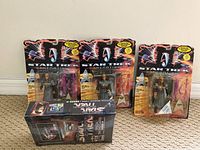 Three Star Trek Generations action figures in original sealed blister packaging with accessories and mini movie posters included