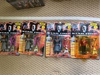Four Star Trek Generations action figures in blister packaging on carpeted floor.