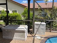 Both storage units side by side in screened enclosure