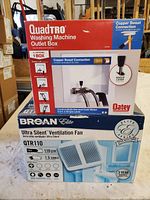 Photo of both boxes stacked showing Broan ventilation fan and QuadTro washing machine outlet box with copper sweat connection.