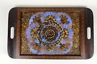 Top-down view of the wooden serving tray with butterfly wing floral inset, showing overall design and colors.