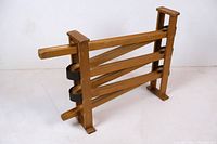 Full view of the wooden marble run showing three parallel sloped wooden tracks in a rectangular wooden frame