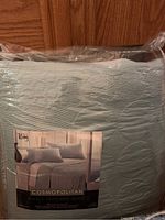 Photo of a packaged King size quilt, Cosmopolitan brand.