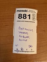 Close-up of sticker listing lot contents: Dell monitor, speakers, keyboard, desktop; 22 inches noted, location BR3.