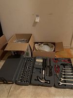 Overall view showing the three domed light fixtures in boxes and the toolbox with tools laid out beside them.