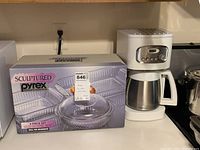 Sculptured Pyrex 4-piece set box and Cuisinart coffee maker on kitchen counter