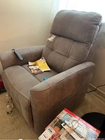 Front view of gray microfiber recliner showing seat, arms and Moto Motion remote on right arm