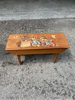 Wooden bench with hand painted folk art bears on seat