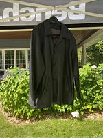 Photo of black leather jacket hanging outdoors