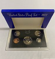 Full view of the opened 1972 United States Proof Set blue case containing five coins in acrylic case.