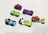 Six Hot Wheels cars with Toy Story themes arranged on white background