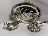 Full view of the lot including the oval Sheridan meat carving platter with ornate handles, the gravy boat, the drip saucer, and the sauce pourer.